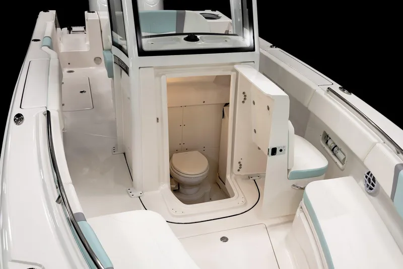 250-118 Yacht Photos Pics Manufacturer Provided Image: 2025 Robalo R250 Center Console boat interior with open console door revealing a compact marine toilet.