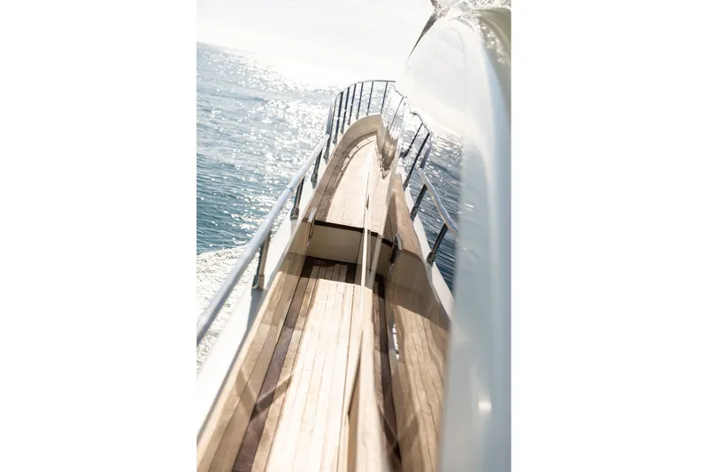 Exit Yacht Photos Pics Side view of 2008 Azimut 75 yacht with wooden deck and ocean backdrop.