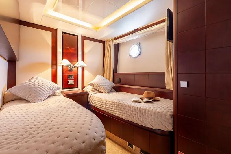 Exit Yacht Photos Pics Luxurious twin cabin interior on 2008 Azimut 75 yacht, featuring elegant wood paneling and cozy bedding.