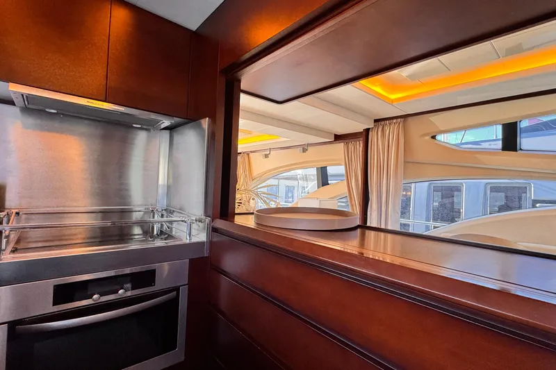 Exit Yacht Photos Pics Luxurious kitchen interior of 2008 Azimut 75 yacht with modern appliances and wood finish.