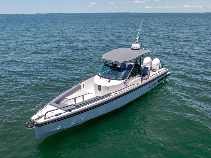  Yacht Photos Pics 2022 Axopar 28 T-Top Brabus boat cruising on open water.