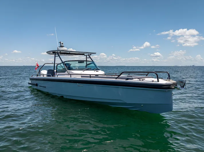  Yacht Photos Pics 2022 Axopar 28 T-Top Brabus boat on open water under clear sky.