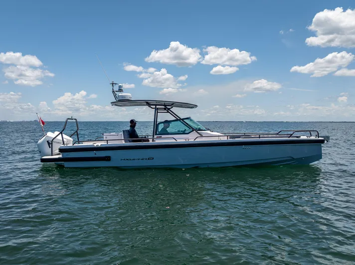  Yacht Photos Pics 2022 Axopar 28 T-Top Brabus boat on open water under blue sky.