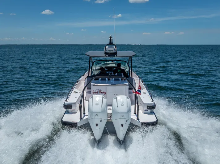  Yacht Photos Pics 2022 Axopar 28 T-Top Brabus cruising on open water, rear view.