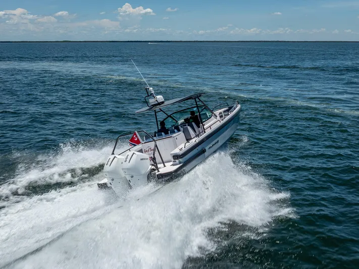  Yacht Photos Pics 2022 Axopar 28 T-Top Brabus speeding on open water, creating waves.