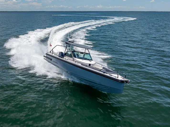  Yacht Photos Pics 2022 Axopar 28 T-Top Brabus speeding on open water, creating a dynamic wake.