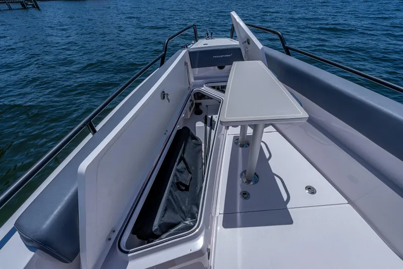  Yacht Photos Pics 2022 Axopar 28 T-Top Brabus boat interior with seating and table on the water.