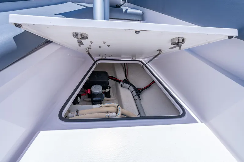  Yacht Photos Pics Open storage compartment on 2022 Axopar 28 T-Top Brabus boat, showing internal wiring and components.