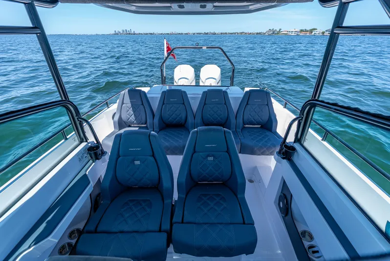 Yacht Photos Pics 2022 Axopar 28 T-Top Brabus boat interior with blue seating on open water.