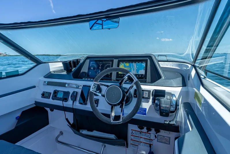  Yacht Photos Pics Cockpit of 2022 Axopar 28 T-Top Brabus with modern navigation system and steering wheel.