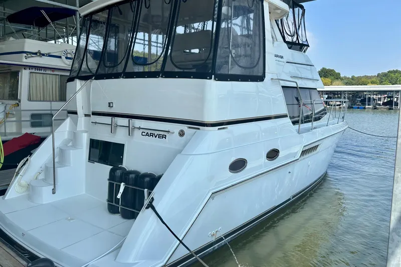  Yacht Photos Pics 2001 Carver 356 Motor Yacht docked at marina, featuring sleek design and spacious deck.