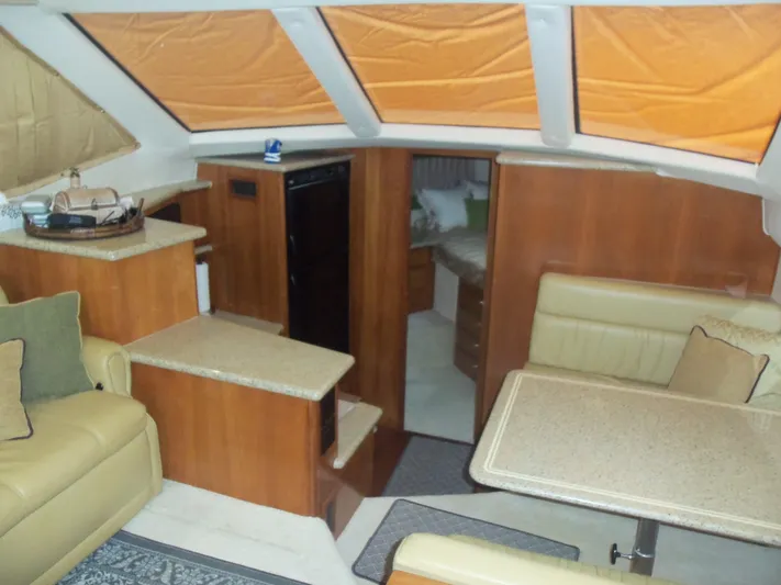  Yacht Photos Pics Interior of 2001 Carver 356 Motor Yacht with seating, table, and kitchenette.