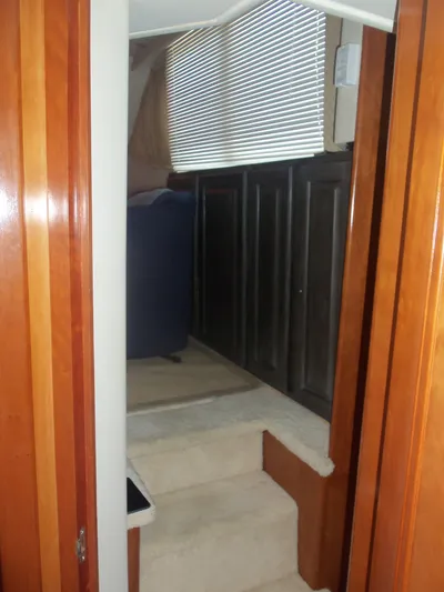  Yacht Photos Pics Interior view of 2001 Carver 356 Motor Yacht with wooden finishes and carpeted steps.