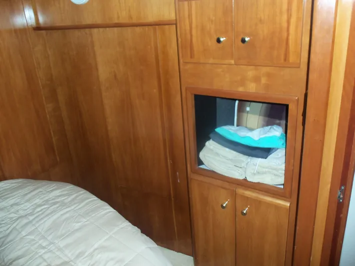  Yacht Photos Pics Wooden interior of 2001 Carver 356 Motor Yacht with storage cabinets and bedding.