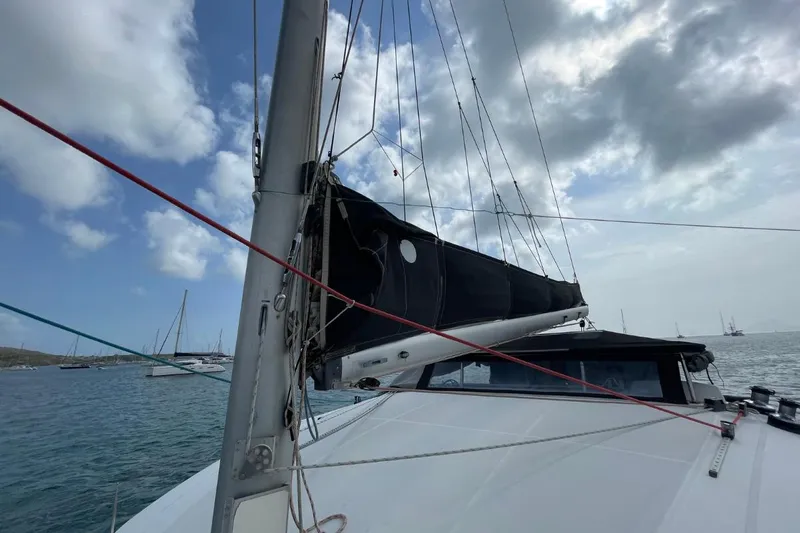 Plan B Yacht Photos Pics Lagoon 380 catamaran sailing on a cloudy day, 2002 model.