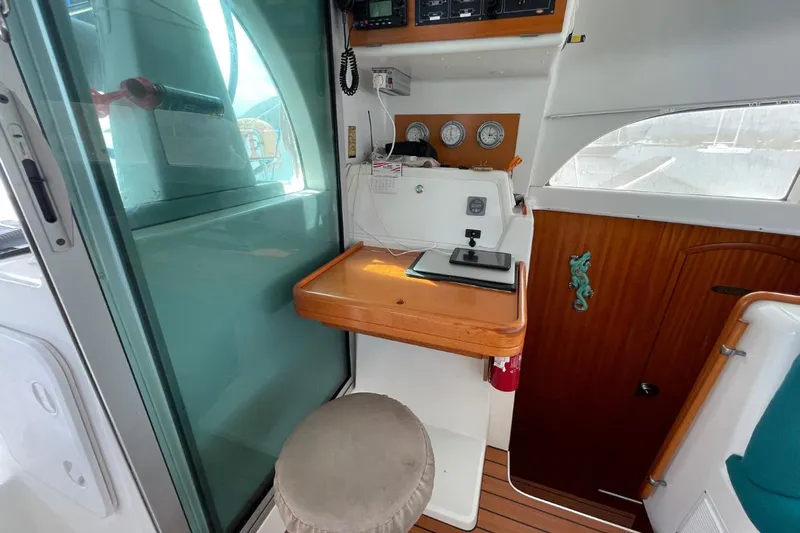 Plan B Yacht Photos Pics Interior of a 2002 Lagoon 380 catamaran with navigation station and wooden accents.