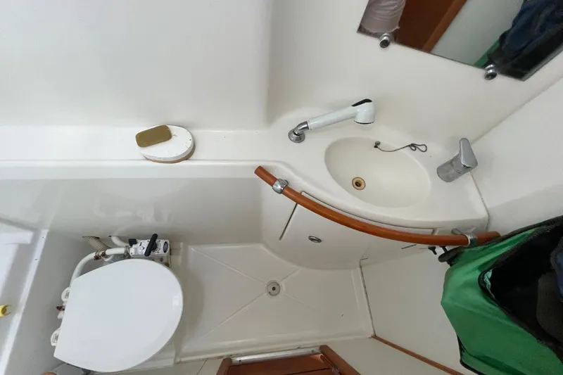 Plan B Yacht Photos Pics Compact bathroom in a 2002 Lagoon 380 catamaran, featuring a sink and toilet.