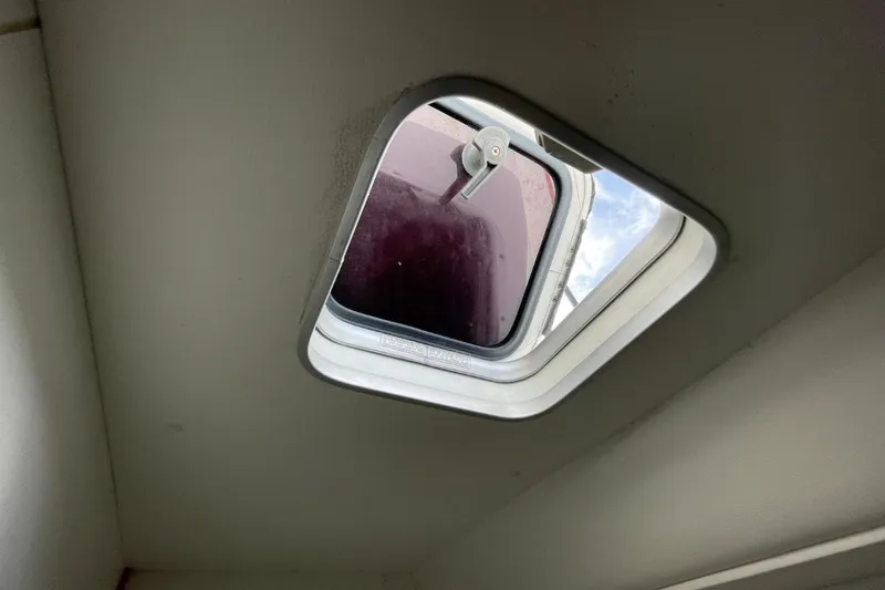 Plan B Yacht Photos Pics Hatch window on a 2002 Lagoon 380 catamaran, partially open to the sky.