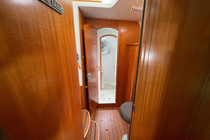 Plan B Yacht Photos Pics Interior of 2002 Lagoon 380 yacht with wooden finish and compact bathroom.