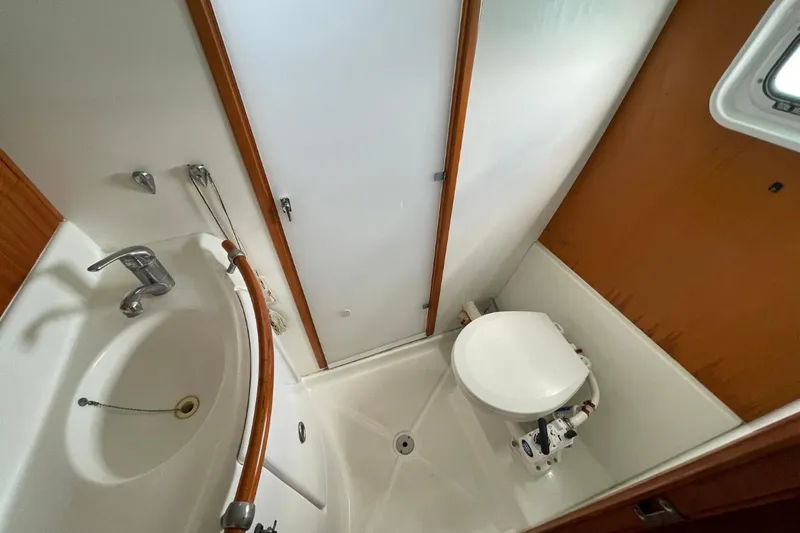 Plan B Yacht Photos Pics Bathroom interior of 2002 Lagoon 380 catamaran with sink and toilet.
