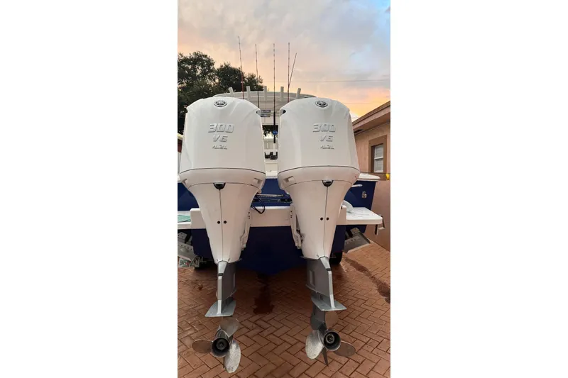  Yacht Photos Pics Twin 300 V6 outboard engines on a 2005 Jupiter 31 boat at sunset.