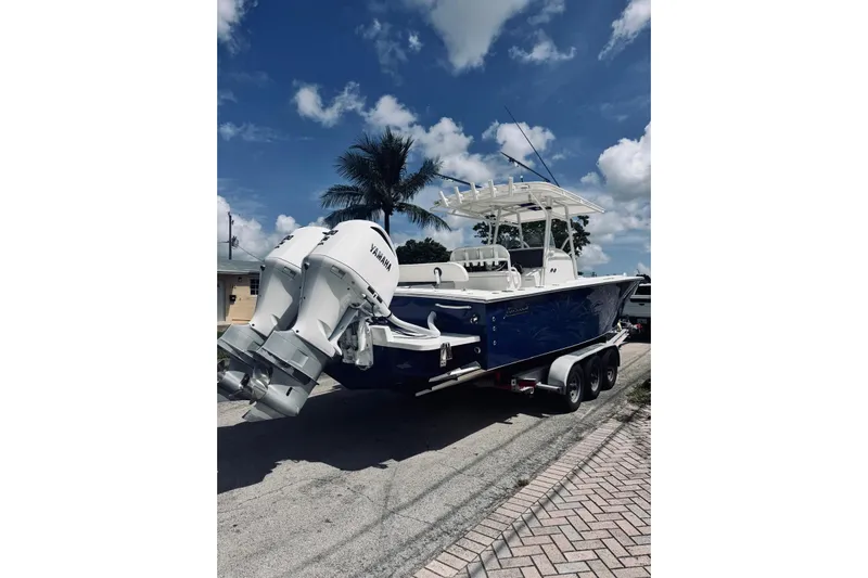  Yacht Photos Pics 2005 Jupiter 31 boat with dual Yamaha engines on a trailer, under a clear sky.