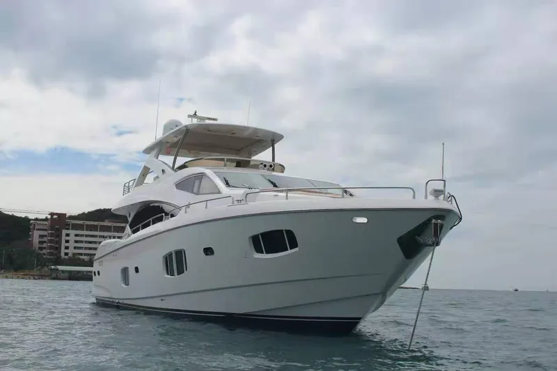  Yacht Photos Pics Luxurious 2011 Sunseeker 88 Yacht anchored in calm waters under a cloudy sky.