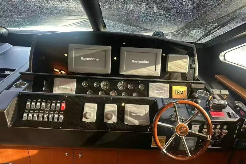  Yacht Photos Pics Cockpit of 2011 Sunseeker 88 Yacht with Raymarine navigation displays and wooden steering wheel.