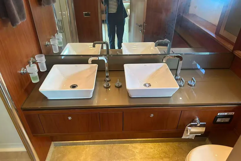  Yacht Photos Pics Luxurious bathroom in 2011 Sunseeker 88 Yacht with dual sinks and elegant wood finish.