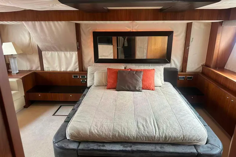  Yacht Photos Pics Luxurious bedroom interior of 2011 Sunseeker 88 Yacht with elegant wood paneling.