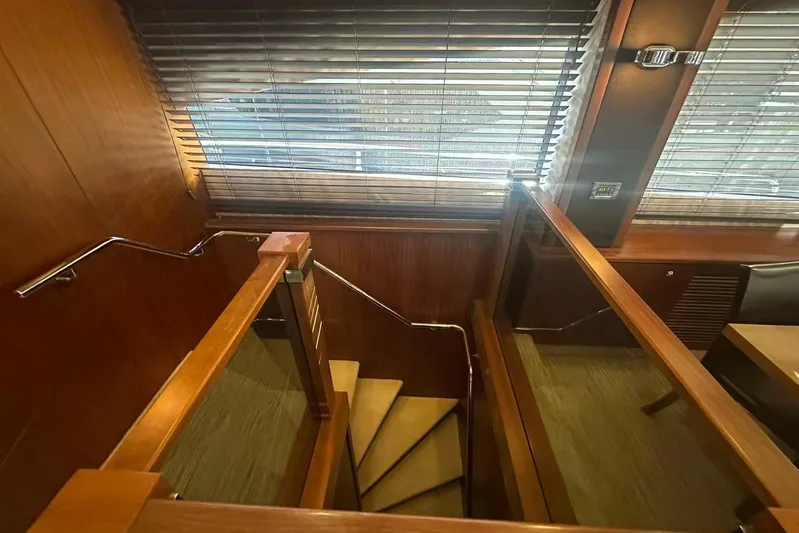  Yacht Photos Pics Interior staircase of 2011 Sunseeker 88 Yacht with wooden paneling and blinds.