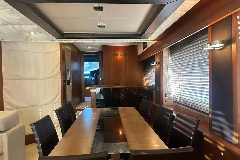  Yacht Photos Pics Luxurious dining area inside 2011 Sunseeker 88 Yacht with elegant wood finishes and modern lighting.
