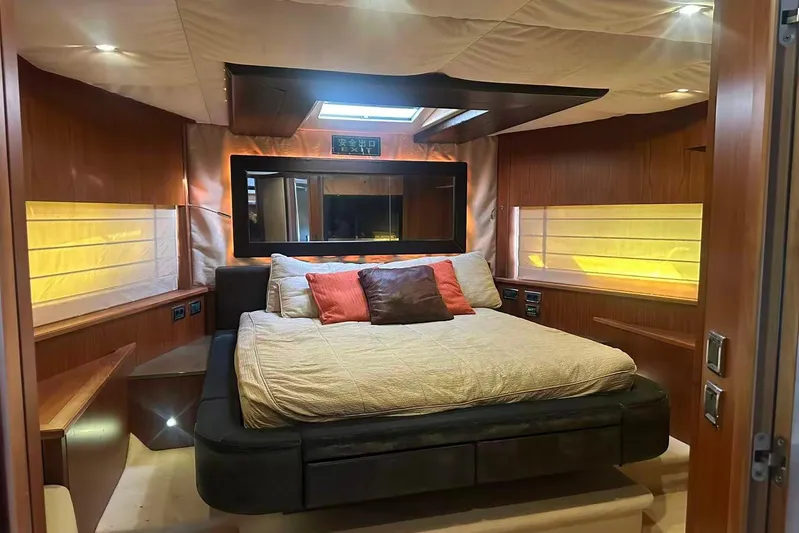  Yacht Photos Pics Luxurious bedroom interior of 2011 Sunseeker 88 Yacht with elegant wood paneling.