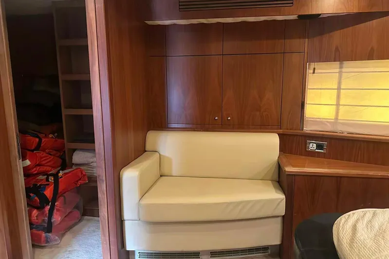  Yacht Photos Pics Interior of 2011 Sunseeker 88 Yacht with beige seating and wooden cabinetry.