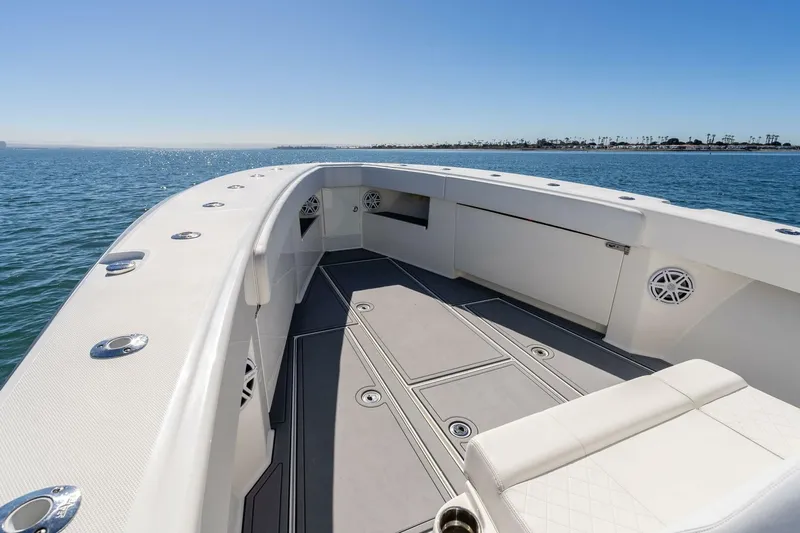 Susan L Yacht Photos Pics 2018 SeaVee 370 Z boat deck with seating, on calm ocean waters.