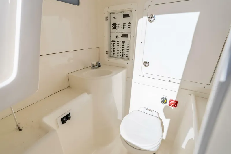 Susan L Yacht Photos Pics 2018 SeaVee 370 Z boat interior with sink, toilet, and control panel.