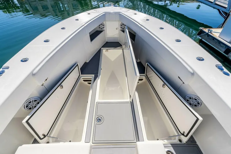 Susan L Yacht Photos Pics 2018 SeaVee 370 Z boat with open storage compartments, docked on calm water.