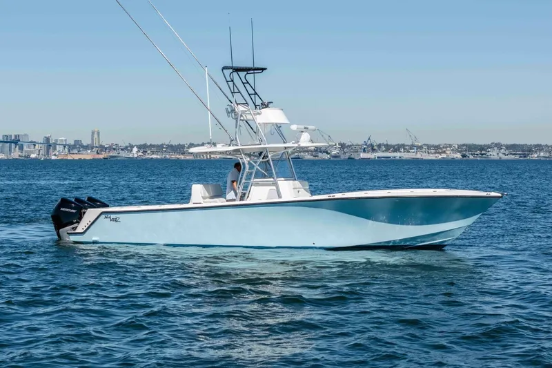 Susan L Yacht Photos Pics 2018 SeaVee 370 Z boat cruising on open water with city skyline in background.
