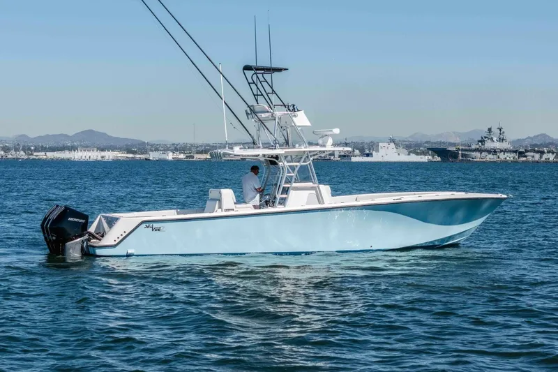 Susan L Yacht Photos Pics 2018 SeaVee 370 Z boat on calm water with distant ships and mountains.
