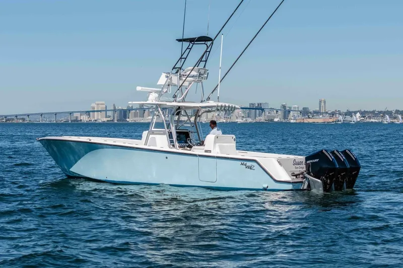 Susan L Yacht Photos Pics 2018 SeaVee 370 Z boat cruising on water with city skyline in background.