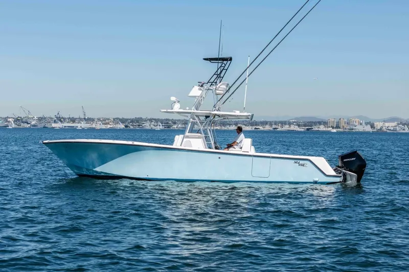 Susan L Yacht Photos Pics 2018 SeaVee 370 Z boat on calm water, clear sky, cityscape background.