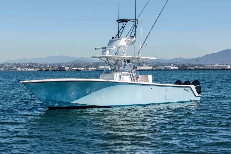 Susan L Yacht Photos Pics 2018 SeaVee 370 Z boat on calm water with cityscape and mountains in background.