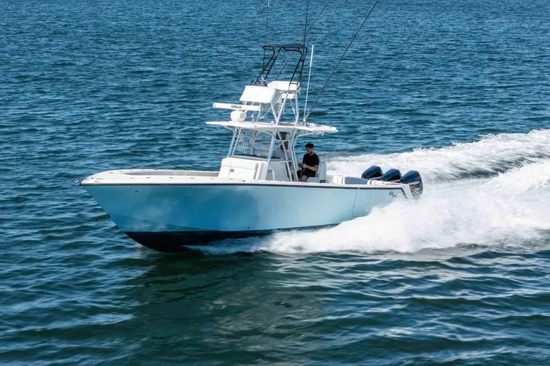 Susan L Yacht Photos Pics 2018 SeaVee 370 Z boat cruising on open water with triple outboard engines.