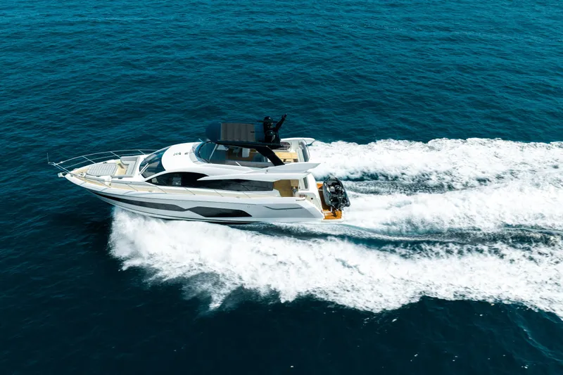 Mahalo Yacht Photos Pics 2018 Sunseeker Manhattan 66 yacht cruising on open blue sea.