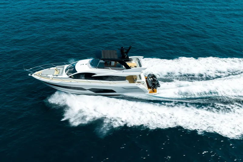 Mahalo Yacht Photos Pics 2018 Sunseeker Manhattan 66 yacht cruising on open blue sea.