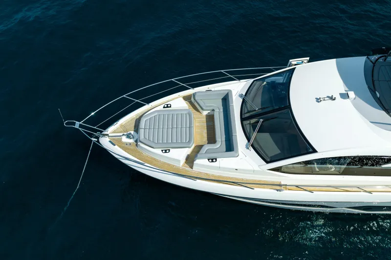 Mahalo Yacht Photos Pics Aerial view of 2018 Sunseeker Manhattan 66 yacht on calm blue water.