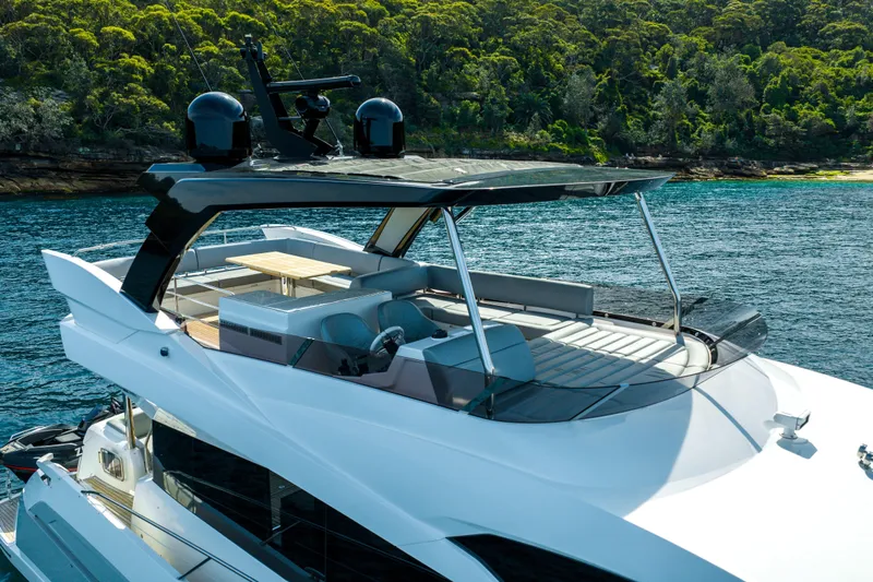 Mahalo Yacht Photos Pics 2018 Sunseeker Manhattan 66 yacht on serene water, lush forest backdrop.