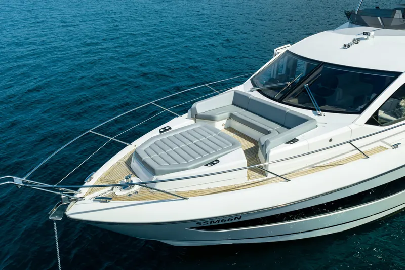 Mahalo Yacht Photos Pics 2018 Sunseeker Manhattan 66 yacht on blue ocean, featuring sleek design and spacious deck.