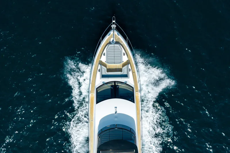 Mahalo Yacht Photos Pics Aerial view of 2018 Sunseeker Manhattan 66 yacht cruising on open water.