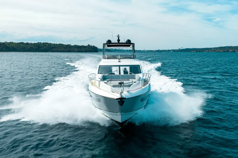 Mahalo Yacht Photos Pics 2018 Sunseeker Manhattan 66 yacht cruising on open water, creating a dynamic wake.